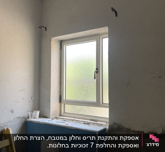 חלון אלומיניום עם מסגרת לבנה בקיר בטון